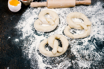 raw pretzel on a floor ready to be baked and ingredients