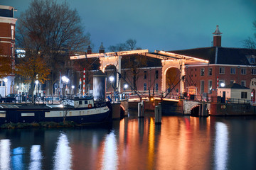 Fototapeta na wymiar Swing bridge over the canal in Amsterdam at night