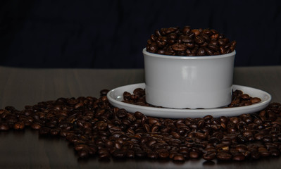 Coffee cup and coffee beans on the table