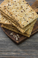 Fototapeta na wymiar Grain loaves on a wooden Board on a wooden gray background. For healthy nutrition