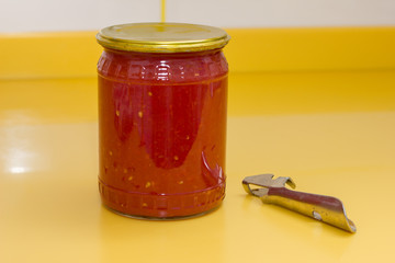 Vitamins on yellow table, tomato paste in glass jar and can opener
