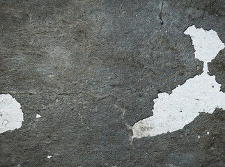 Texture of an old cracked concrete wall. Background image of a worn gray concrete surface