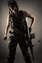 female soldier in uniform with machine gun