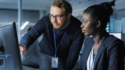 African American Female Scientist Works on a Computer Caucasian Male Colleague Joins Her With Work...