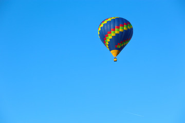 hot air balloon in the sky on a blue background