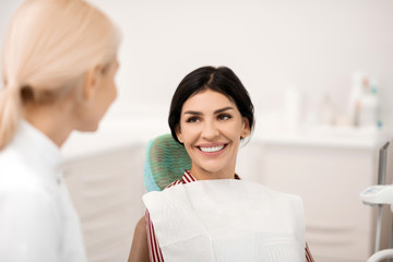 Woman being happy at her future teeth whitening.