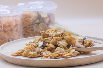 Delicious cereal caramel cornflakes warm tone background. A Breakfast cereal made by flakes of corn.