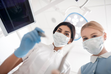 Dentist and her assistant beginning the operation.