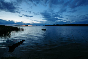 silhouette of a fisherman against a sunset sky