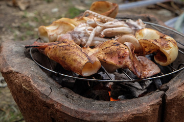 Big squid grilled on fire traditional cooking