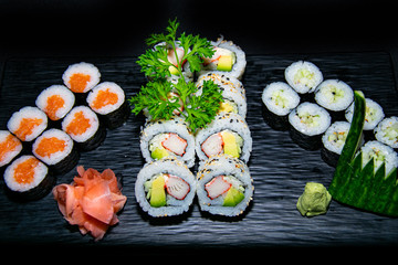 a selection of salmon and avocado hosomaki and california sushi rolls 