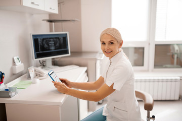 Dentist smiling to her client entering the office.