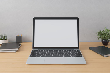 Fototapeta premium Laptop with mockup screen on the table in interior.