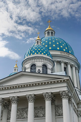 Fototapeta na wymiar St. Petersburg, Russia - August 10, 2019 - a fragment of the Holy Trinity Cathedral with bas-reliefs on the pediment and beautiful domes