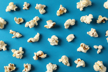 Flat lay composition with popcorn on blue background, closeup