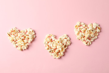 Flat lay composition with popcorn hearts on pink background, space for text