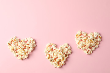 Flat lay composition with popcorn hearts on pink background, space for text