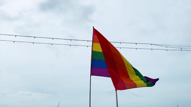 rainbow flag on a cloudy sky