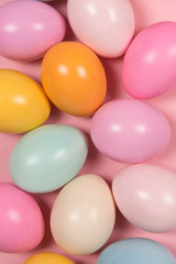 Easter background with soft pastel easter eggs in a full frame image seen from an high angle view