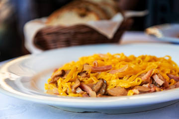 tasty pasta with roast ham on the table