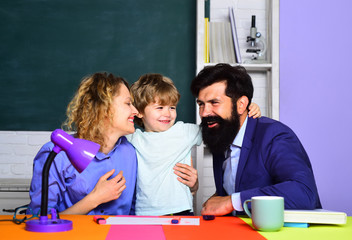 Back to school. Parents helps child boy. Home family schooling. Mathematics for kids. Schoolboy learning letters and numbers with parents. Parents teaching kid private lessons in math. Home schooling.