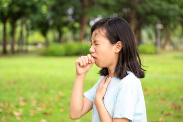 Fototapeta premium Sick child girl suffering from sore throat,painful swallowing,asian female patient have coughing,irritation sore throat,holding hand on her neck ,inflammation,bacterial infections diseases,allergies