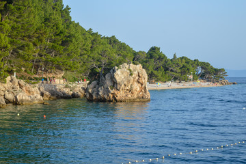 Naklejka premium Adriatic Sea beach in the resort town of Brela, Croatia. Islet on Punta Rata beach in the resort town of Brela, Makarska riviera of Dalmatia, Croatia