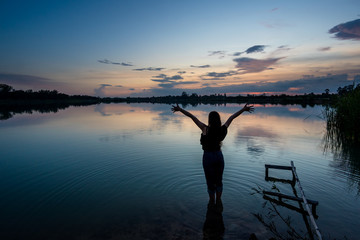 Woman in the lake on sunset