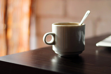 Coffee mug on a black table.