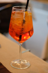 Glass of spritz with a straw