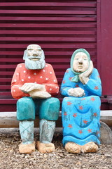 Wooden painted figures in the park. Handwork of the joiner.