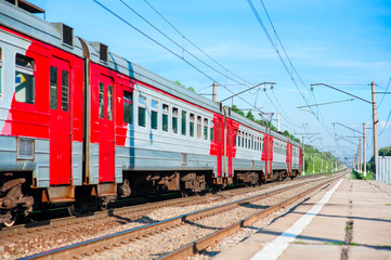 Fototapeta premium Electric train pulls up to the station platform