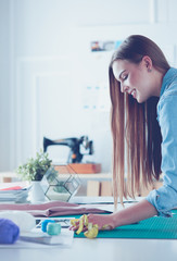 Fashion designer working on her designs in the studio
