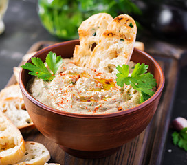 Baba ghanoush vegan hummus from eggplant with seasoning, parsley and toasts. Baba ganoush. Middle Eastern cuisine.