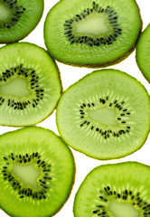 Fototapeta premium Close-up slices of kiwi on light white backgroun