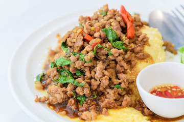 Fried basil with pork on an omelette