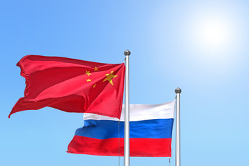china and russia national flag waving against sunny blue sky side view of natural color of people republic of china and russian federation state symbols isolated for design mockup copy space template