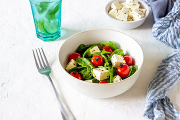 Salad with tomatoes, spinach and cheese. Italian cuisine. Healthy eating. Diet.