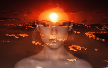 Double exposure of young woman and sunset sky.