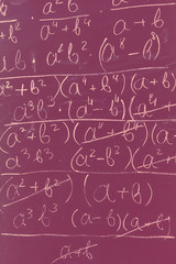 Maths formulas written by white chalk on the chalkboard background.