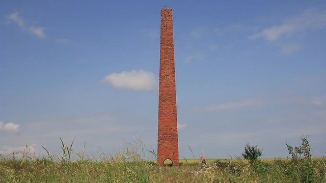 Red Brick Chimney In A Field.