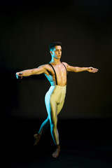 Classic male ballet dancer performing in spotlight