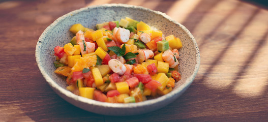 Delicious fruits salad in plate on table close-up