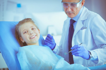 Fototapeta premium Little girl sitting in the dentists office