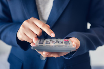 Close-Up of Business Accountant Financial Using Calculator for Estimated Tax Earning Account,...