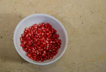 Pomegranate on white plate, ingredient of 