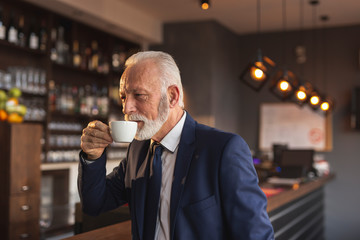 Senior businessman on a coffee break