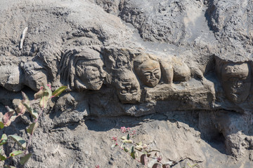 The mystery face carved into rock at entrance of Bentar Candi and Batok volcano in Bromo Tengger Semeru National Park, East Java, Indonesia.