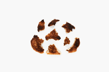 Sliced ​​and crumbs of highly fried bread isolated on white.