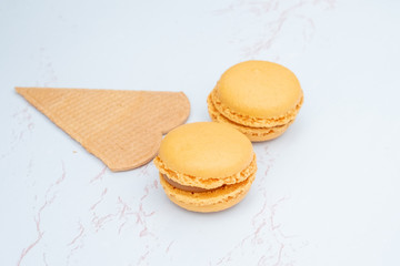 Fun flat lay composition of the colorful and sweet tasting small French cake macaron or macaroon combined with cookies